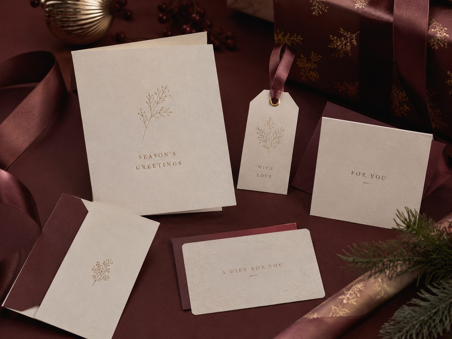 Seasonal gift cards and tags in burgundy and gold