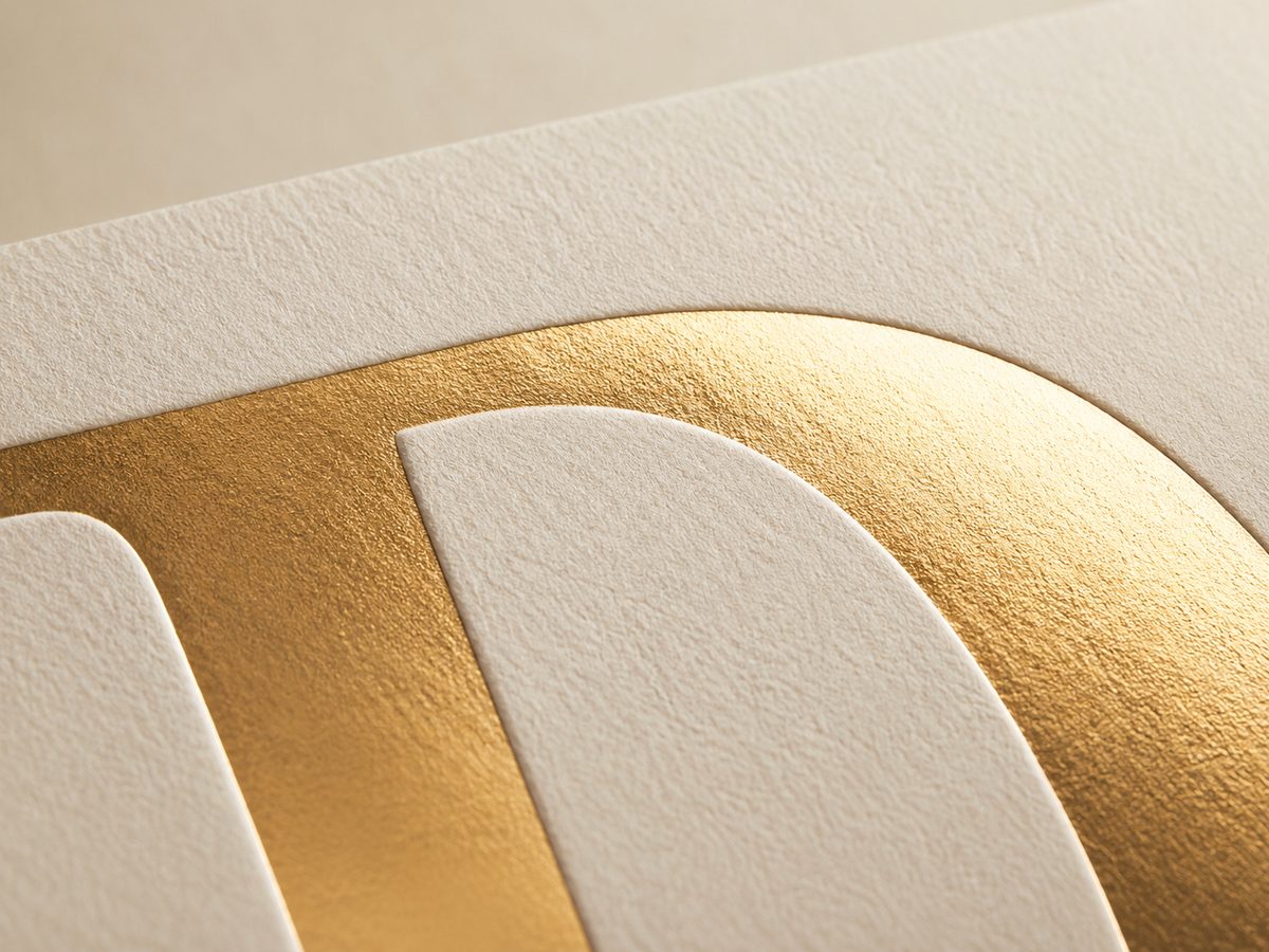 Gold foil letterform stamped under heat