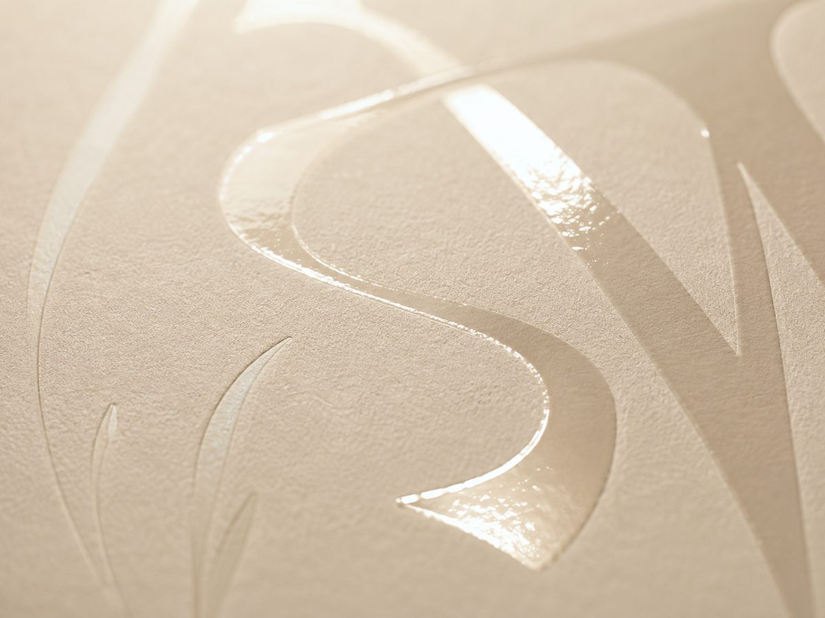 Spot gloss varnish catching the light on a matte card
